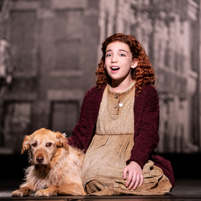 Annie with dog sitting on the stage