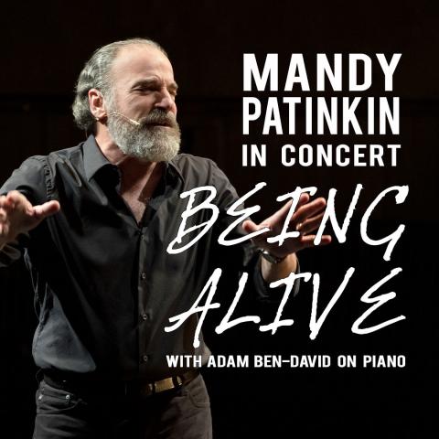 Mandy Patkin with his logo Mandy Patinkin In Concert: Being Alive to the right of him