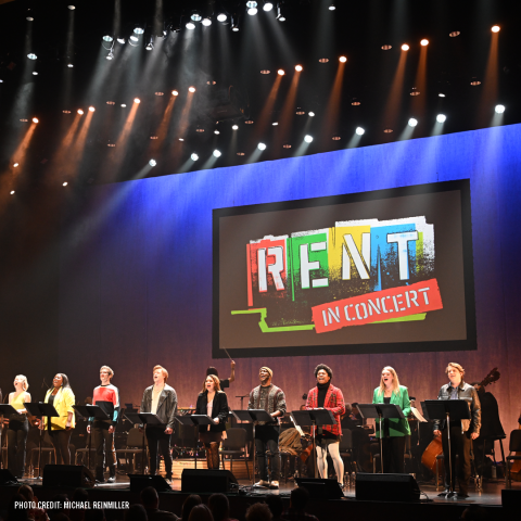 Rent singers on stage under the RENT logo