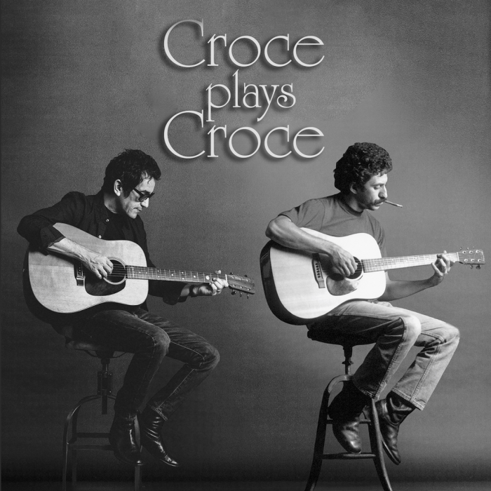 Two guys playing guitars sitting on stools.