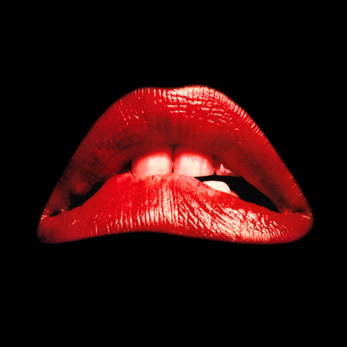 The famous Rocky Horror red lips biting the bottom lip.