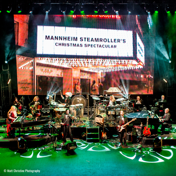 Mannheim Steamroller band underneath a marquee