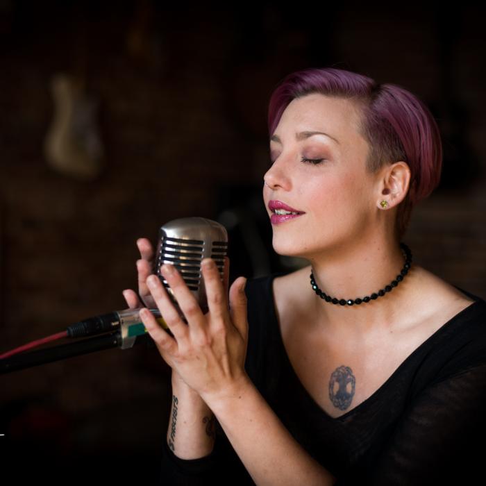 Megan Dooley holding the mic with both hands