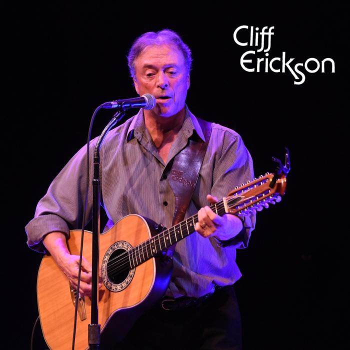 Image of Cliff Erickson singing and playing guitar on stage