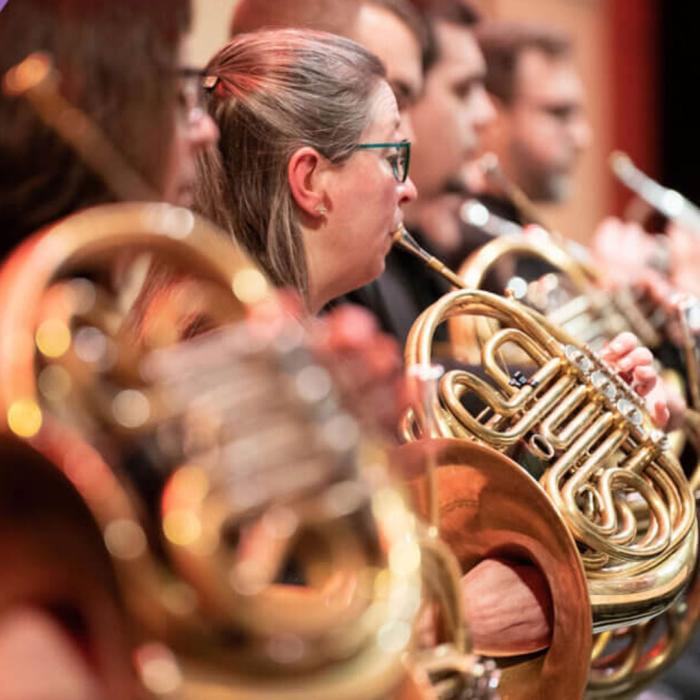 A close up of the French Horn section of the Kalamazoo Symphony Orchestra.