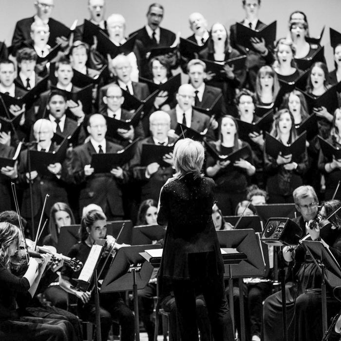 Conductor in front of an orchestra and choir