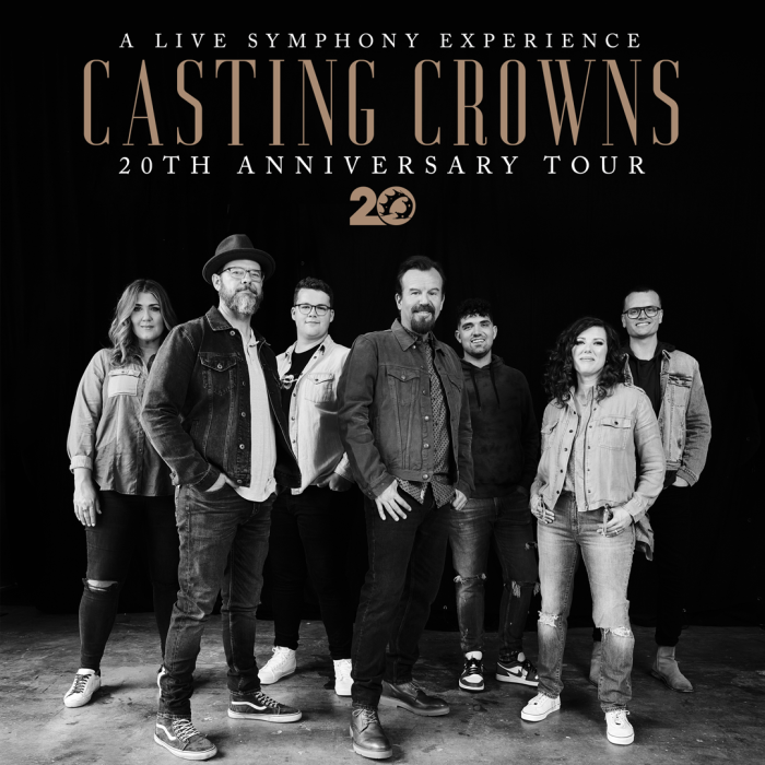 Black and white photo of the Casting Crowns band standing under the logo
