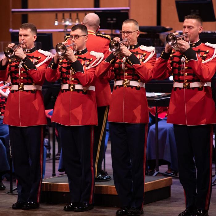 Trumpet player standing playing the trumpets